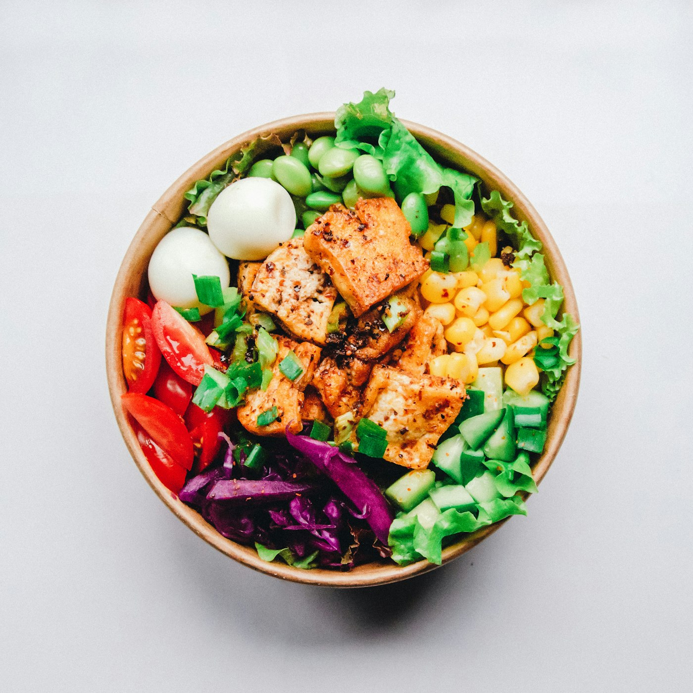 A grain bowl with vegetables and herbs